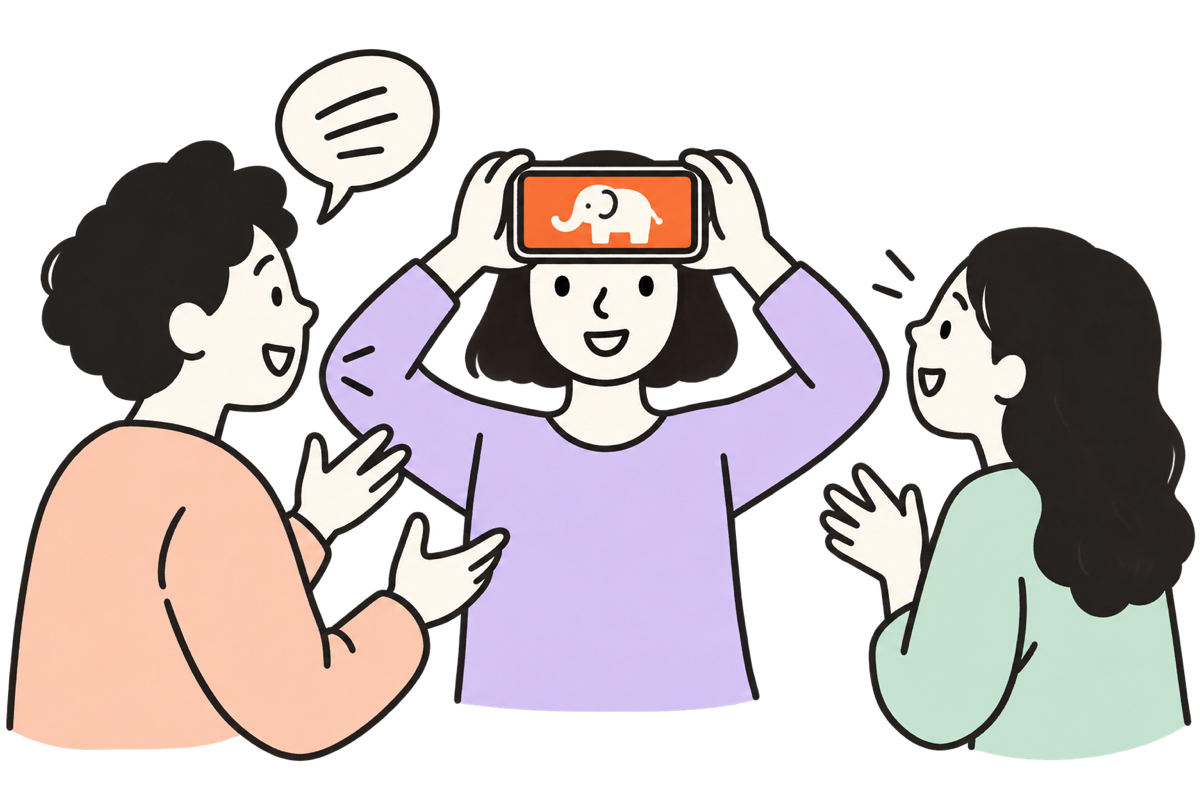 Three friends laughing while one holds a phone to her forehead showing an elephant